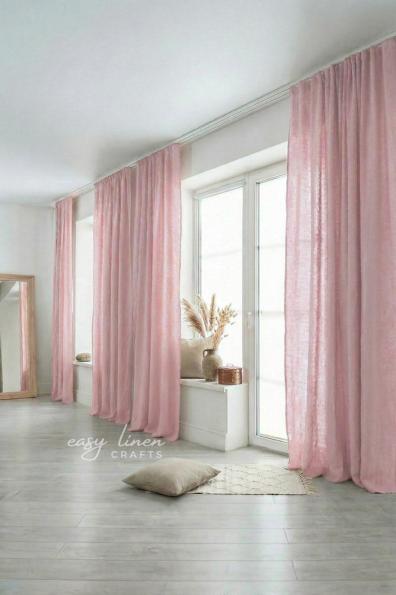 Pink curtains in a room with a mirror and decor items.