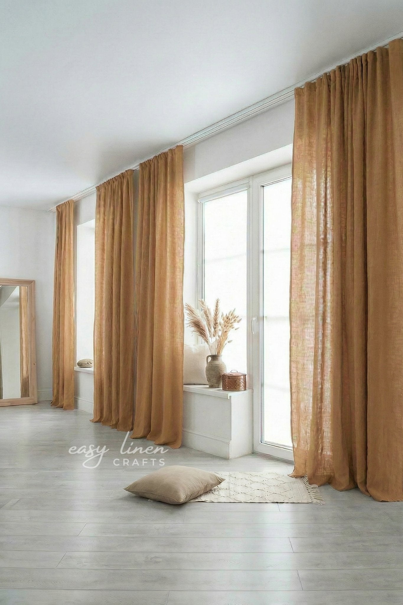 Brown curtains in a room with a mirror and vase on a windowsill.