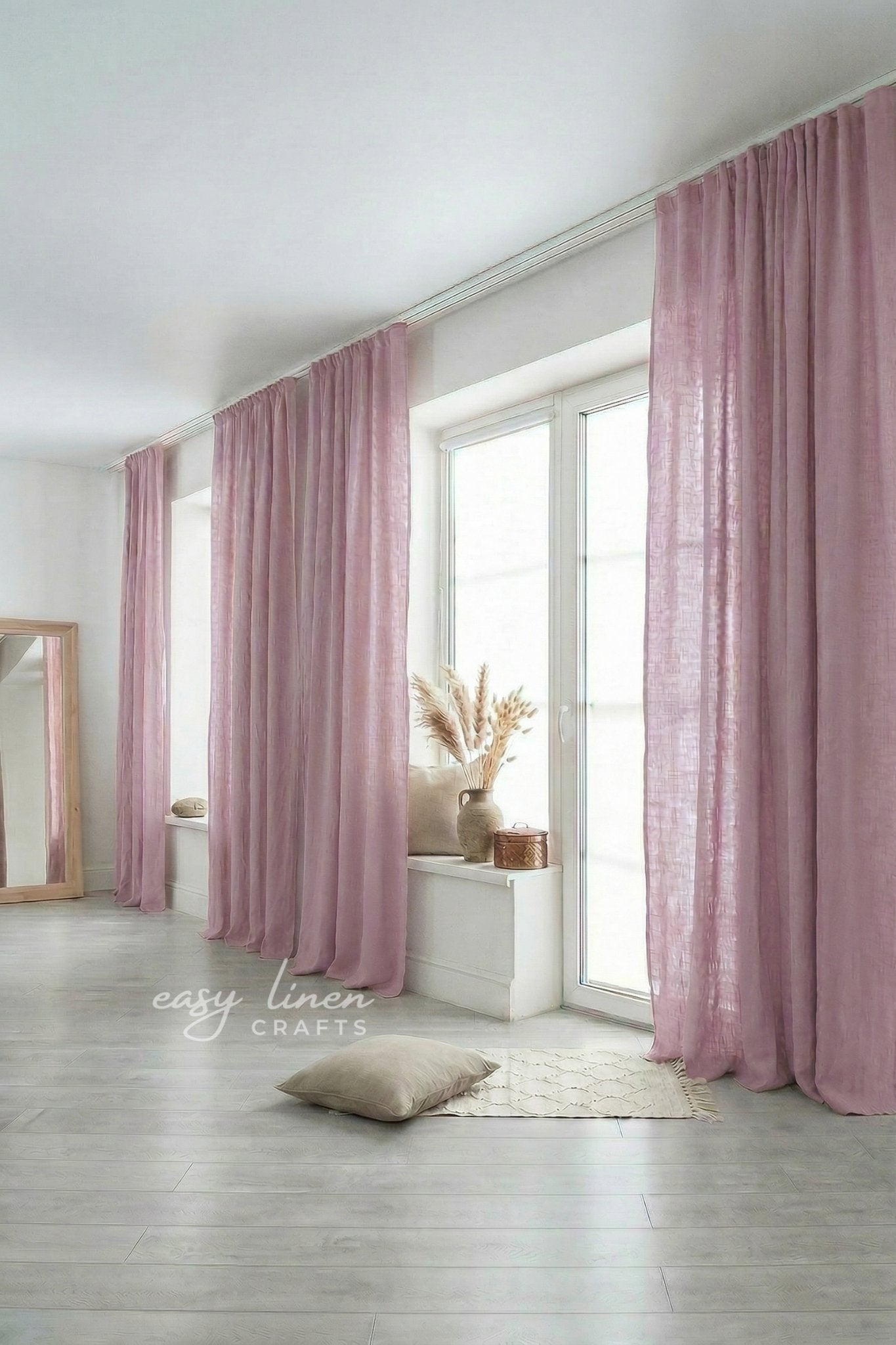 Pink curtains in a room with a mirror and decor items.