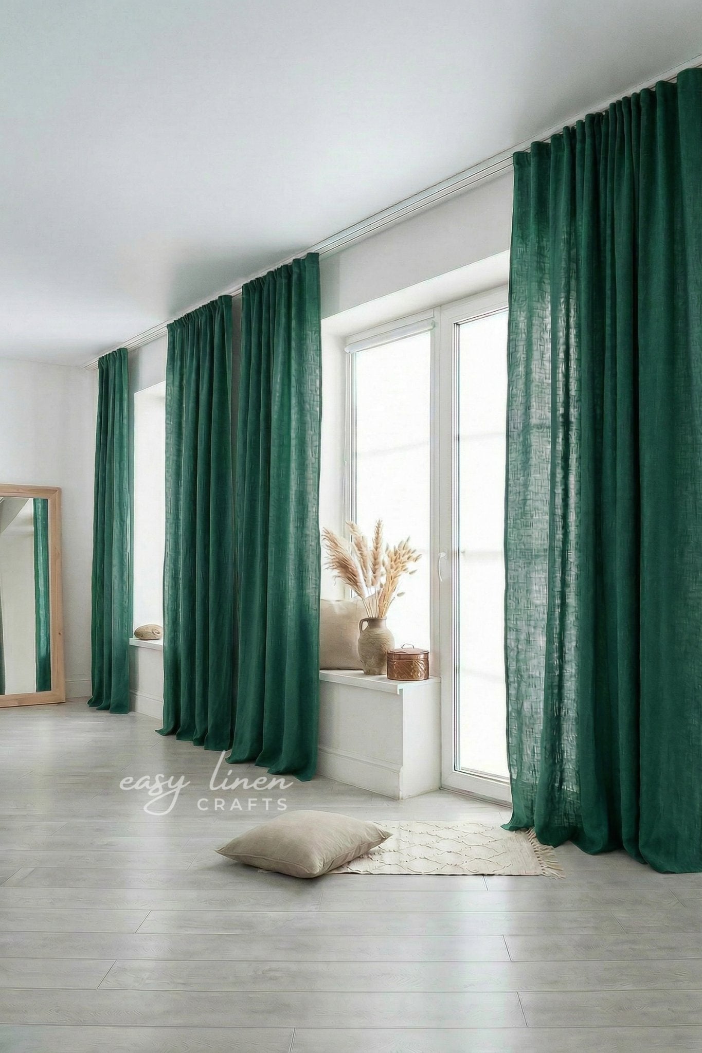 Green curtains in a room with a mirror and decor items.