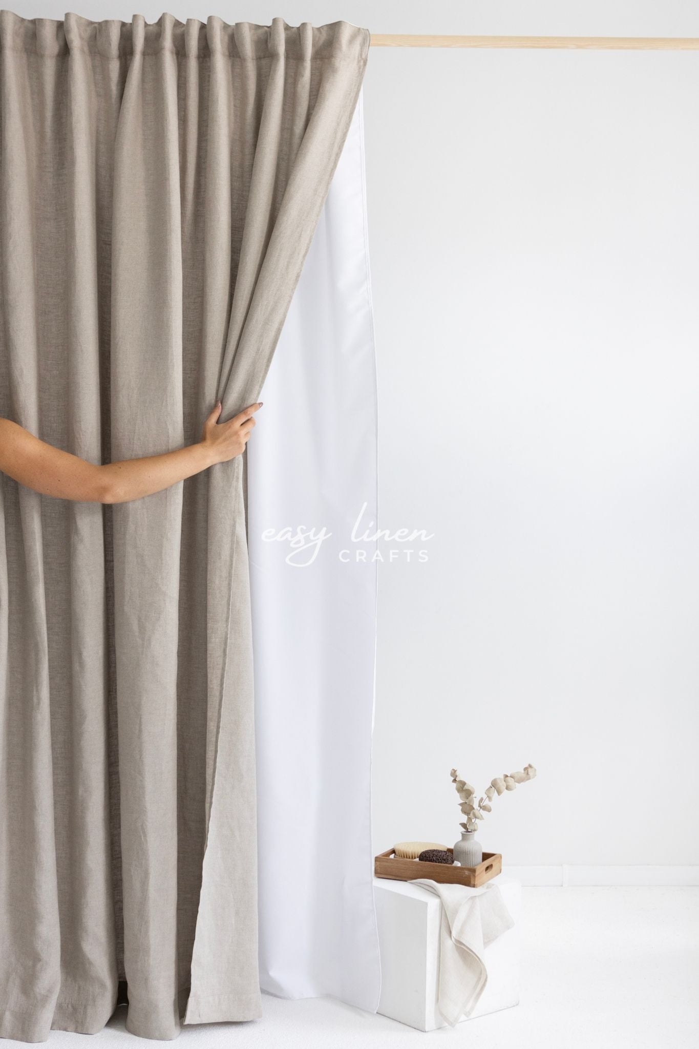 Person holding a beige shower curtain against a white background with 'Lush Linen' branding.