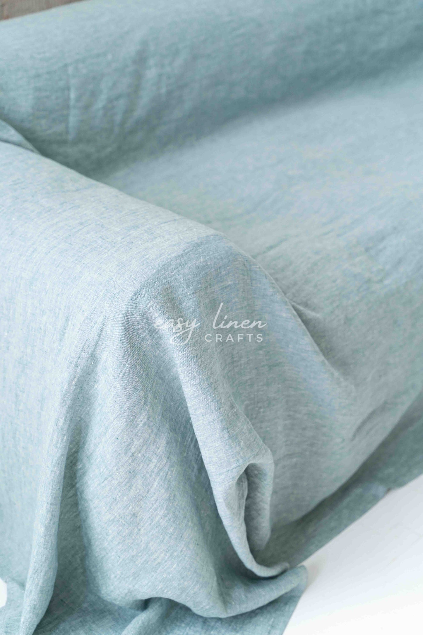 Linen couch cover in Melange Green color. Custom sizes available