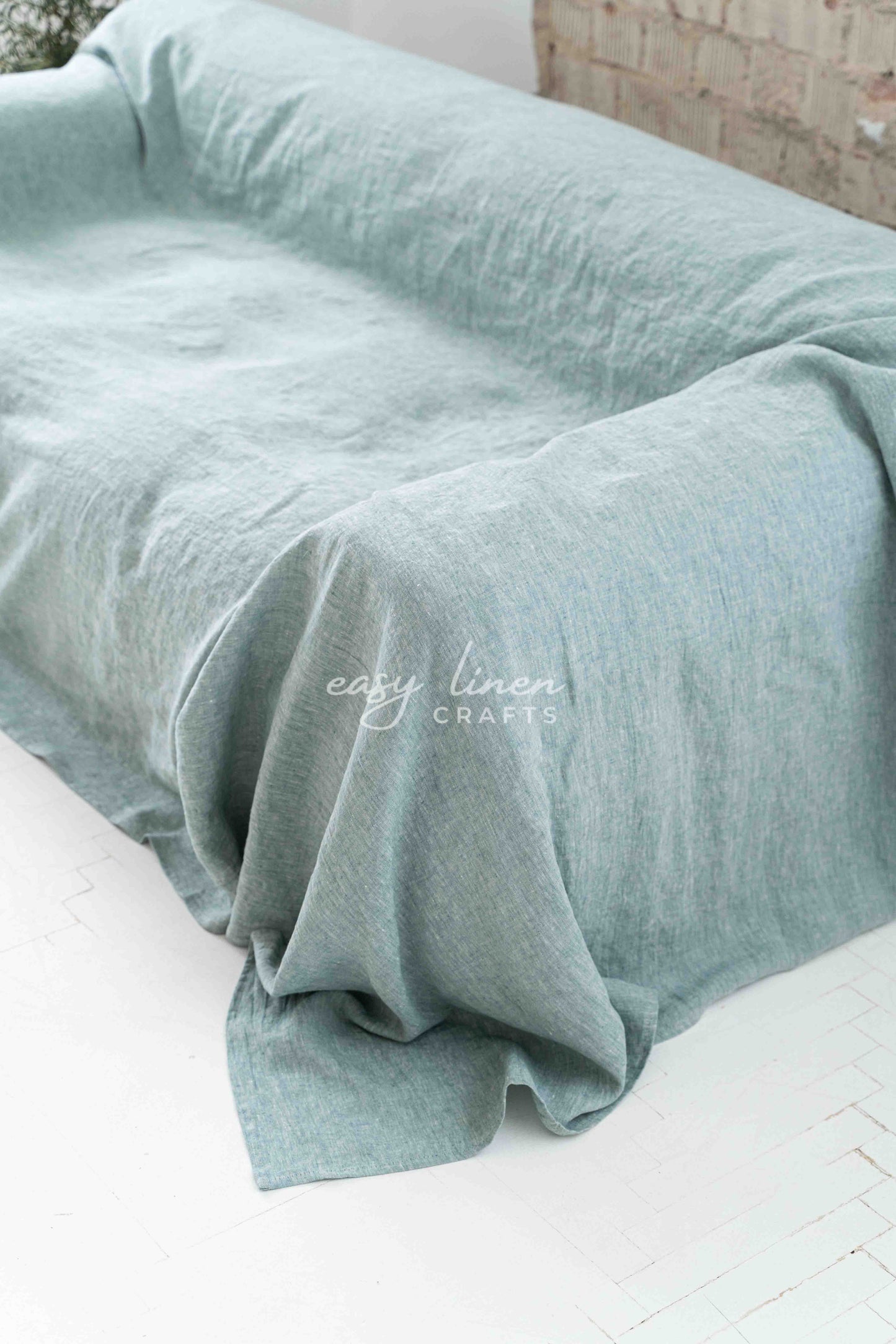 Linen couch cover in Melange Green color. Custom sizes available