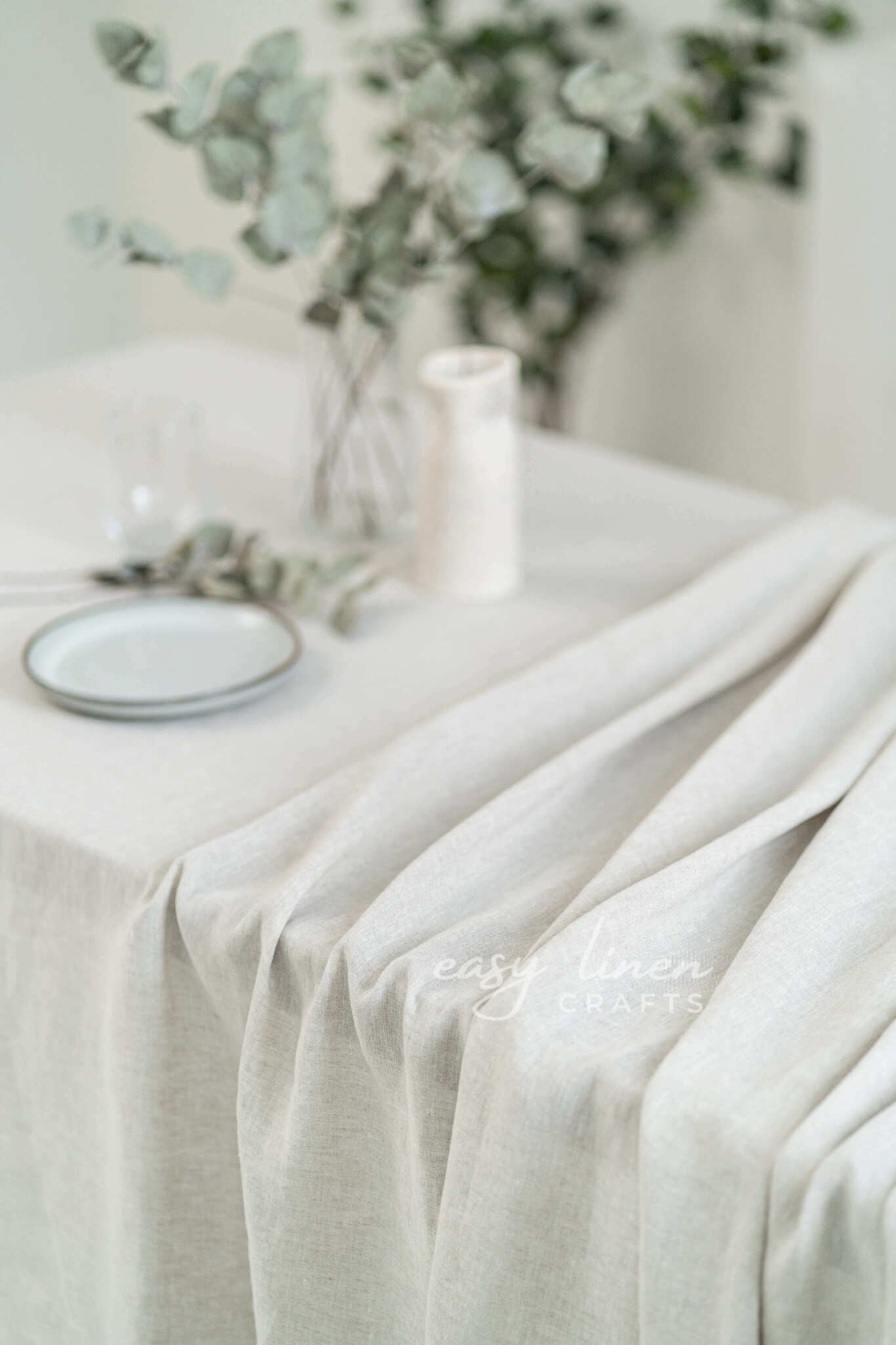 Light-colored tablecloth on a table with a blurred background