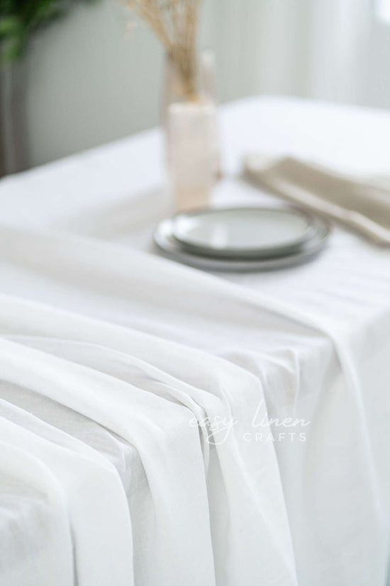 White linen tablecloth with a plate on a blurred background