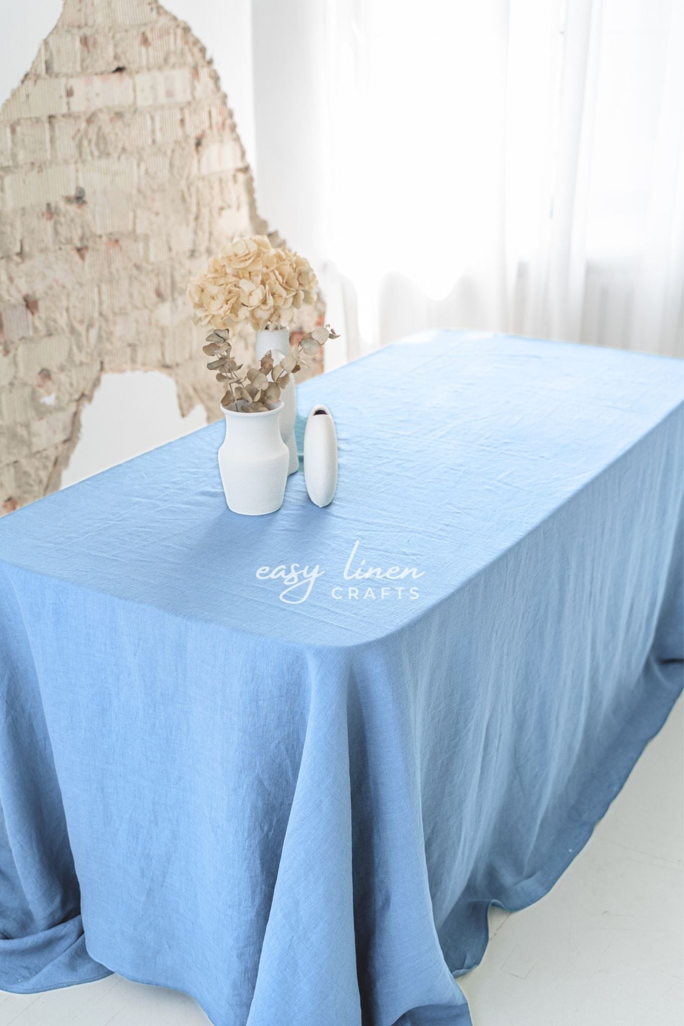 Blue tablecloth on a table with decorative items