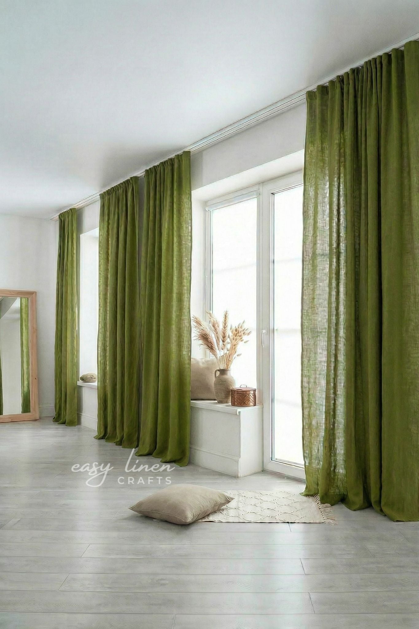Green curtains in a room with a mirror and decor items.
