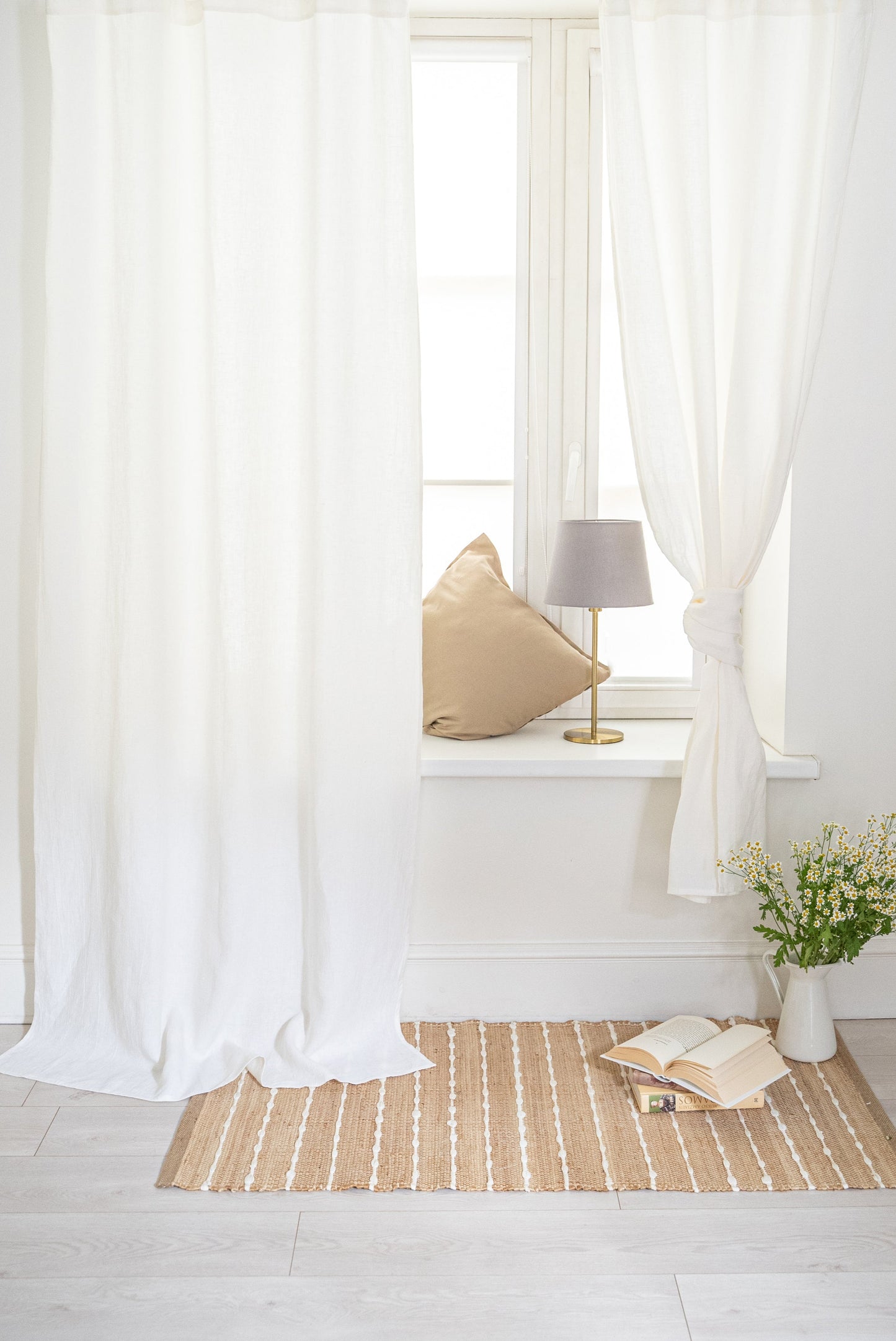 Off White curtains with a small table and lamp in a bright room