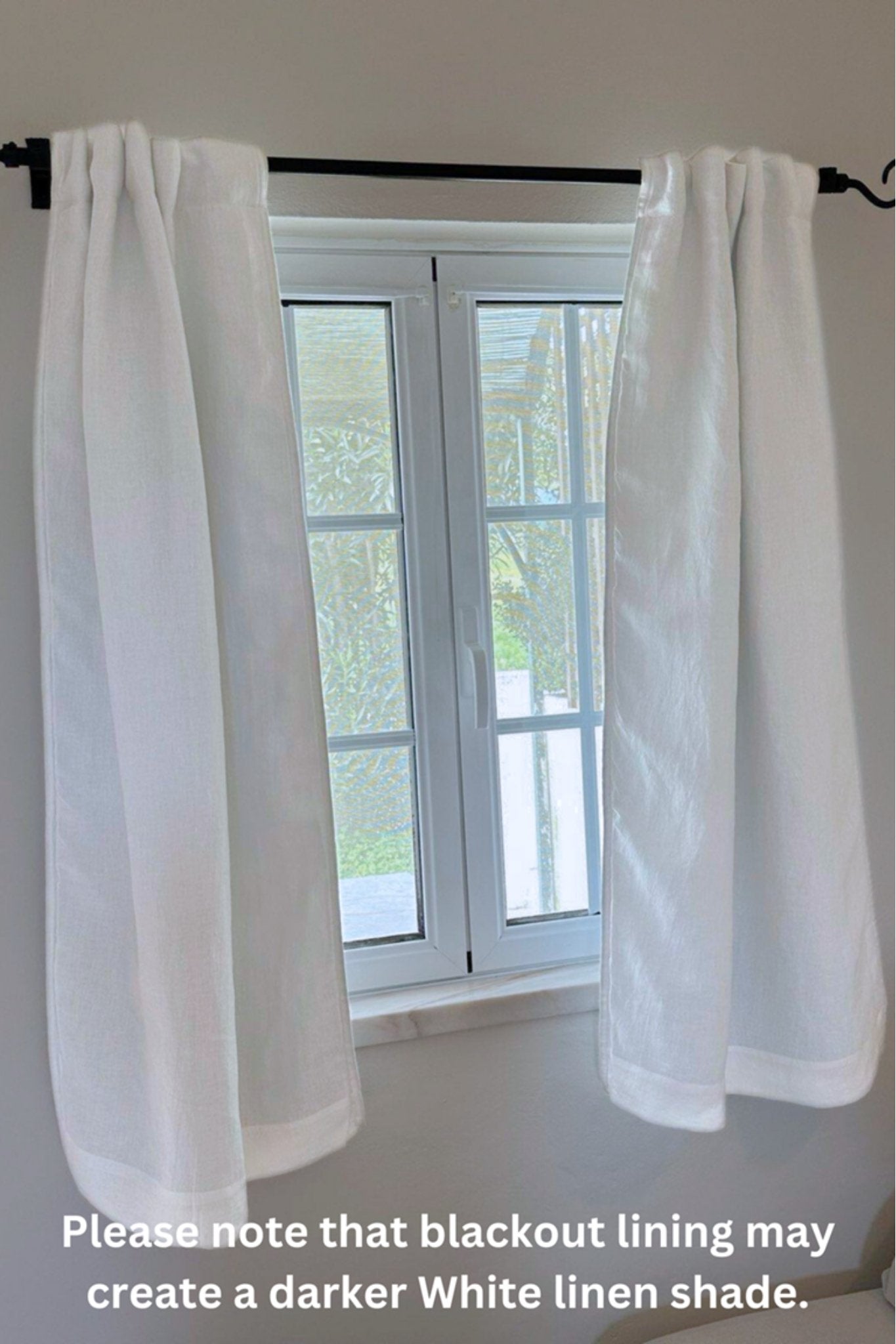White curtain panels hanging from a black rod over a white window, with a text note at the bottom about blackout lining creating a darker white linen shade.