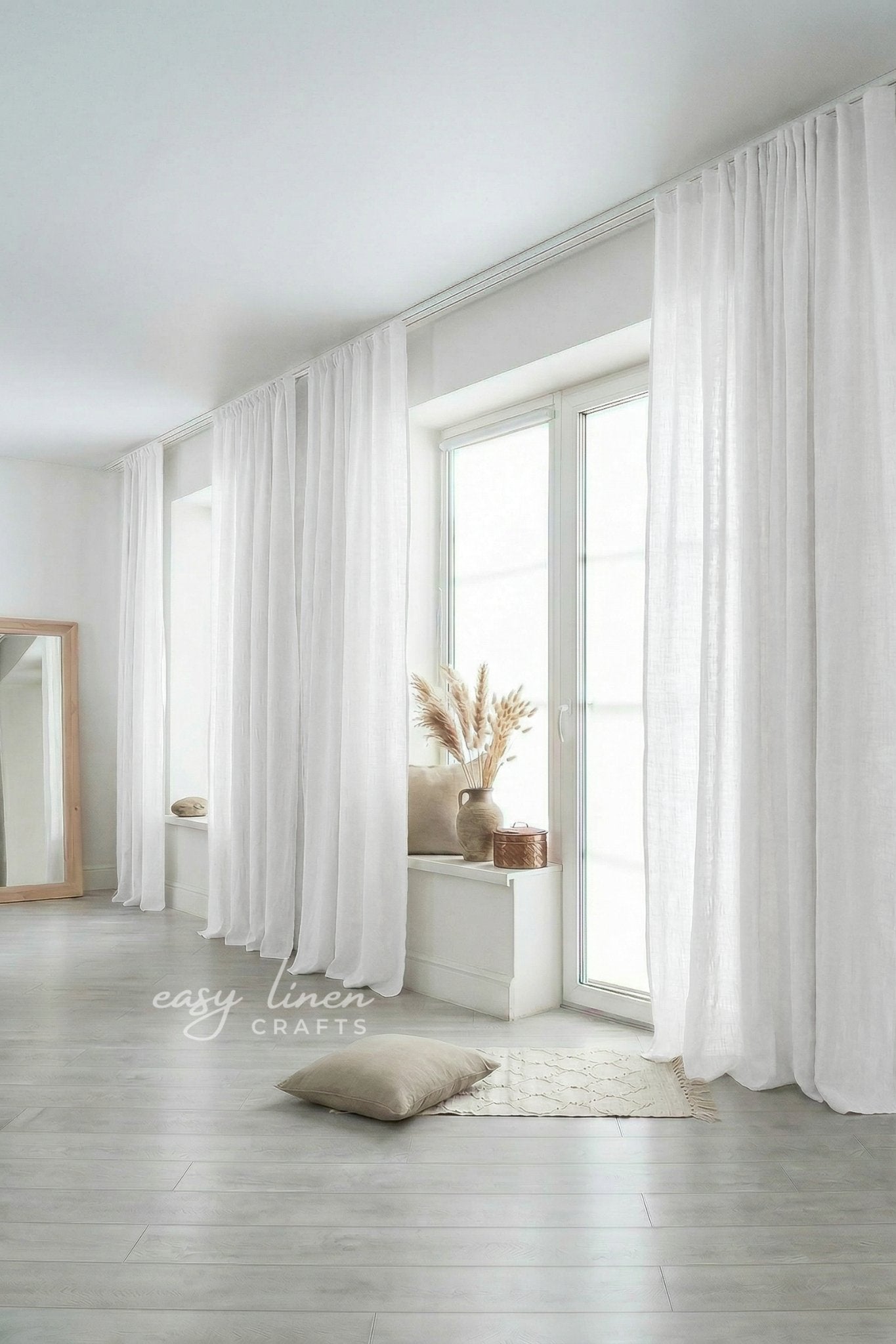 White curtains in a room with a mirror and decor items.